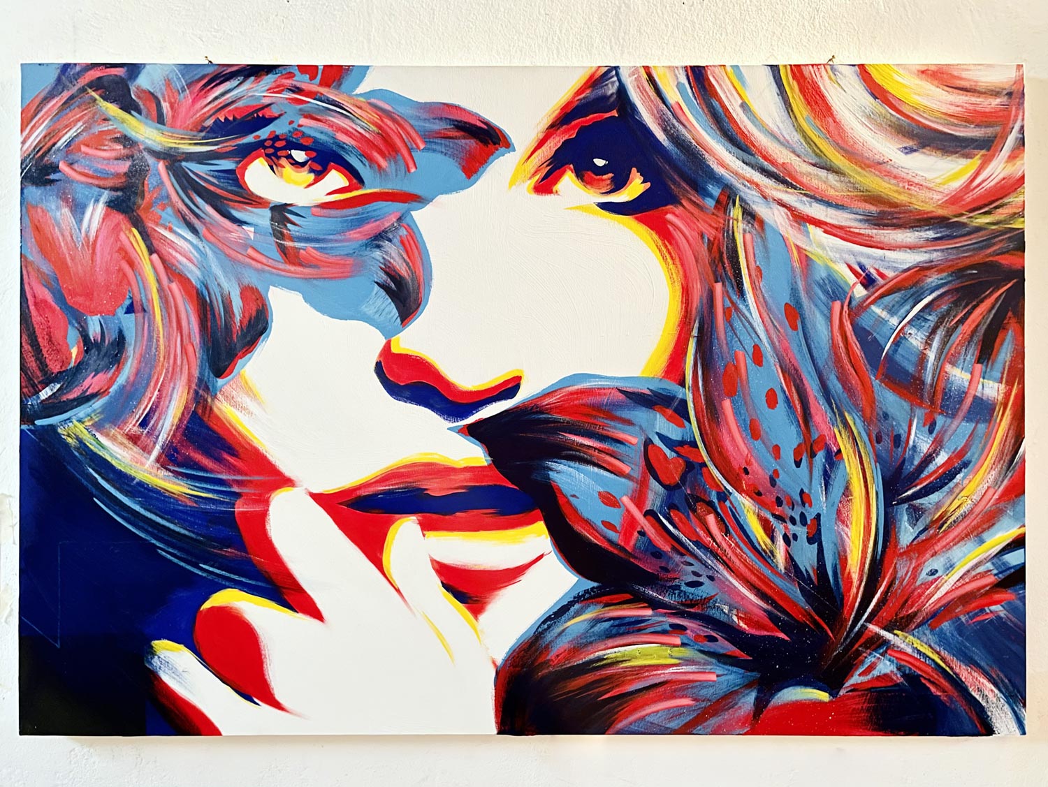 Female face emerging from a mosaic of vibrant textures and bold lines.