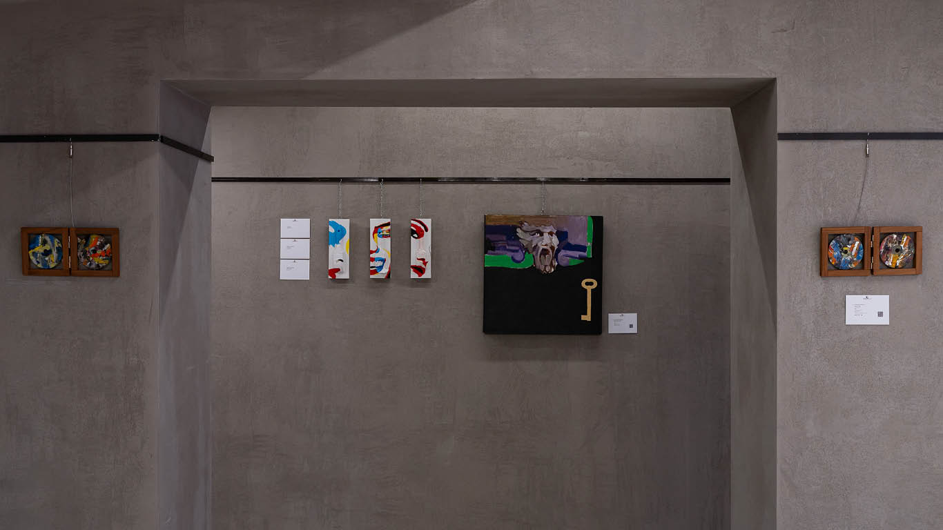Exhibition view featuring DutyGorn's Brushes artworks alongside works by Giorgio Gatto (2018) and Alfred Milot Mirashi (2008), displayed on a grey gallery wall.
